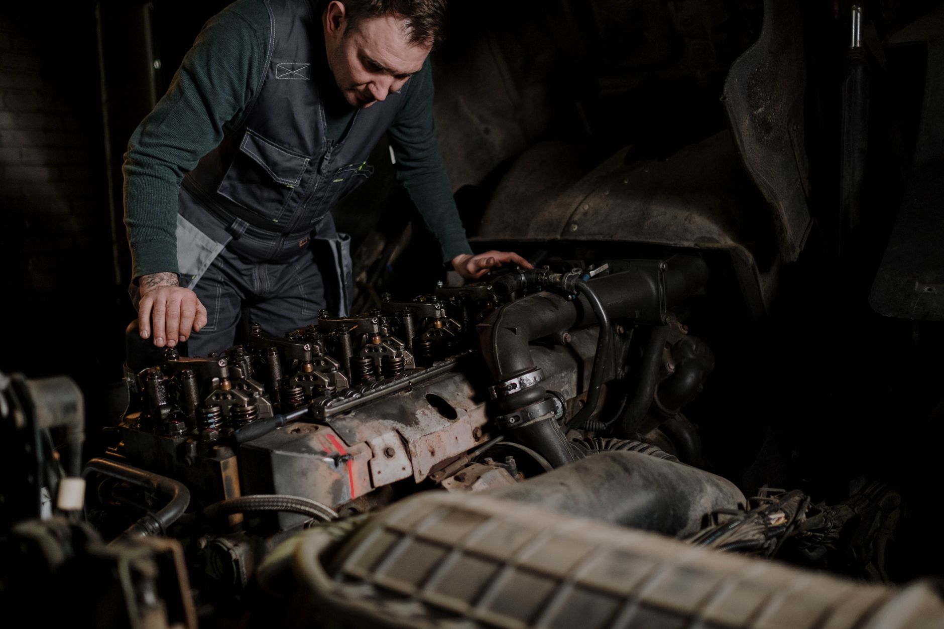 Diesel mechanic working on truck engine